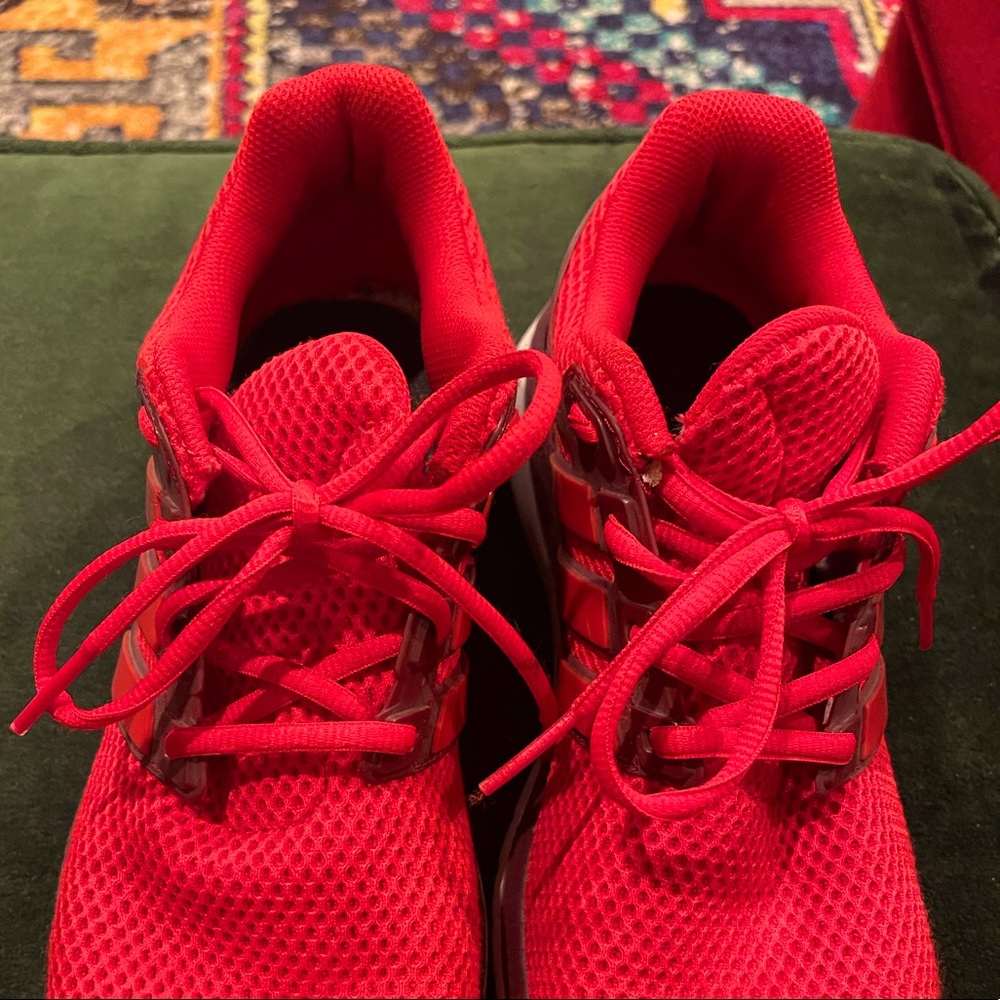 Red adidas tennis shoes. Sneakers. Running shoe